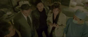 Movie still from “Enter the Void” (2009), directed by Gaspar Noé – A group of people standing next to each other in a room; Medium shot, High angle