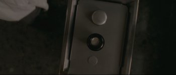 Movie still from “Enter the Void” (2009), directed by Gaspar Noé – View of a button on a device; Extreme Close Up shot, Overhead angle