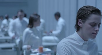 Movie still from “Equals” (2015), directed by Drake Doremus – A group of people sitting around a table; Close Up shot, Over the shoulder angle