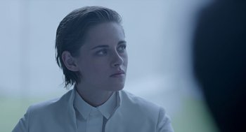 Movie still from “Equals” (2015), directed by Drake Doremus – A person wearing a suit and tie; Close Up shot, Over the shoulder angle
