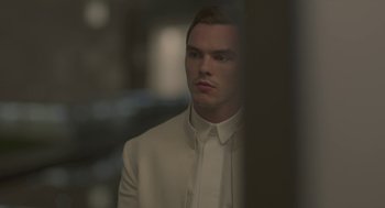 Movie still from “Equals” (2015), directed by Drake Doremus – A man in a white suit looking into the distance; Close Up shot, Over the shoulder angle