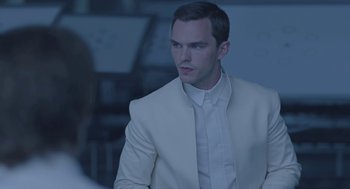 Movie still from “Equals” (2015), directed by Drake Doremus – A man in a white suit looking to his left; Close Up shot, Over the shoulder angle