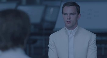 Movie still from “Equals” (2015), directed by Drake Doremus – A man wearing a white suit and a white tie; Close Up shot, Over the shoulder angle