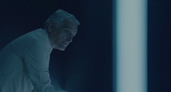 Movie still from “Equals” (2015), directed by Drake Doremus – An older man is looking at the camera; Close Up shot, Low angle