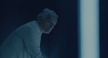 Movie still from “Equals” (2015), directed by Drake Doremus – An older man in a white shirt is looking into the distance; Close Up shot, Low angle