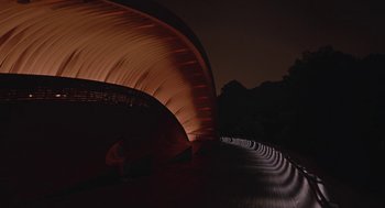 Movie still from “Equals” (2015), directed by Drake Doremus – A person standing in front of a tunnel at night; Extreme Wide shot, Low angle