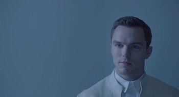 Movie still from “Equals” (2015), directed by Drake Doremus – A man in a white dress shirt is looking at the camera; Close Up shot, Low angle