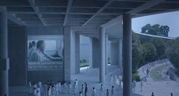 Movie still from “Equals” (2015), directed by Drake Doremus – A group of people walking around a building with pillars; Extreme Wide shot, High angle