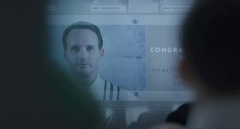 Movie still from “Equals” (2015), directed by Drake Doremus – A man is looking at a computer screen; Close Up shot, Over the shoulder angle
