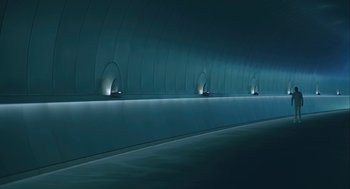 Movie still from “Equals” (2015), directed by Drake Doremus – A long tunnel with a bunch of lights on the wall; Extreme Wide shot, High angle