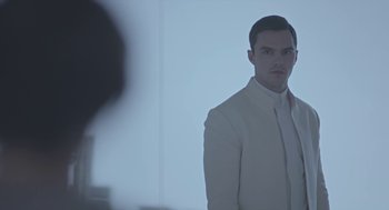 Movie still from “Equals” (2015), directed by Drake Doremus – A man in a white suit standing in front of a mirror; Close Up shot, Low angle