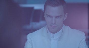 Movie still from “Equals” (2015), directed by Drake Doremus – A person wearing a suit and tie; Close Up shot, Over the shoulder angle