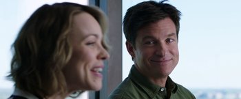 Movie still from “Game Night” (2018), directed by John Francis Daley – A man and a woman smiling for the camera; Close Up shot, Over the shoulder angle
