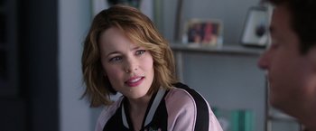 Movie still from “Game Night” (2018), directed by John Francis Daley – A person wearing a pink and black jacket; Close Up shot, Over the shoulder angle