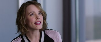 Movie still from “Game Night” (2018), directed by John Francis Daley – A person sitting in front of a window; Close Up shot, Over the shoulder angle