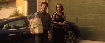 Movie still from “Game Night” (2018), directed by John Francis Daley – A man and a woman standing in front of a garage door; Medium shot, Over the shoulder angle