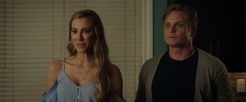 Movie still from “Game Night” (2018), directed by John Francis Daley – A man and a woman standing next to each other in a room; Close Up shot, Over the shoulder angle