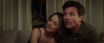 Movie still from “Game Night” (2018), directed by John Francis Daley – A man and a woman sitting next to each other in a room; Close Up shot, Over the shoulder angle