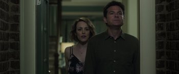 Movie still from “Game Night” (2018), directed by John Francis Daley – A man and a woman standing next to each other; Medium shot, Low angle