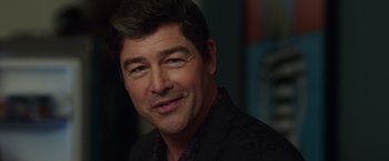 Movie still from “Game Night” (2018), directed by John Francis Daley – A person wearing a suit; Close Up shot, Over the shoulder angle