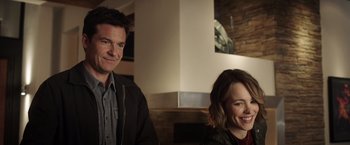 Movie still from “Game Night” (2018), directed by John Francis Daley – A man and a woman smiling for the camera; Close Up shot, Over the shoulder angle
