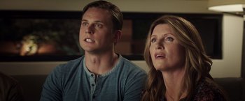 Movie still from “Game Night” (2018), directed by John Francis Daley – A man and a woman are looking at the camera; Close Up shot, Low angle