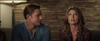 Movie still from “Game Night” (2018), directed by John Francis Daley – A man and a woman sitting next to each other in front of a brick wall; Close Up shot, Over the shoulder angle