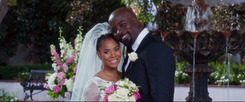 Movie still from “Girls Trip” (2017), directed by Malcolm D. Lee – A man and a woman posing for a wedding picture; Close Up shot, High angle