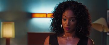 Movie still from “Girls Trip” (2017), directed by Malcolm D. Lee – A person with curly hair wearing a necklace; Close Up shot, Over the shoulder angle