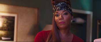 Movie still from “Girls Trip” (2017), directed by Malcolm D. Lee – A person wearing a head scarf; Close Up shot, Over the shoulder angle