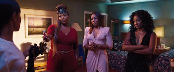 Movie still from “Girls Trip” (2017), directed by Malcolm D. Lee – Two women standing next to each other in a room; Medium shot, Over the shoulder angle