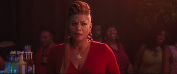 Movie still from “Girls Trip” (2017), directed by Malcolm D. Lee – A person wearing a red shirt; Close Up shot, Over the shoulder angle