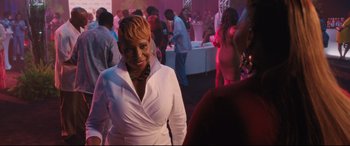 Movie still from “Girls Trip” (2017), directed by Malcolm D. Lee – A woman in a white shirt at an event; Medium shot, Over the shoulder angle
