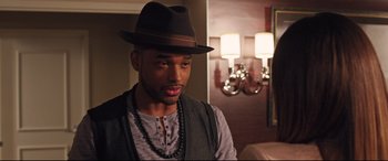 Movie still from “Girls Trip” (2017), directed by Malcolm D. Lee – A man wearing a hat and a necklace; Close Up shot, Over the shoulder angle