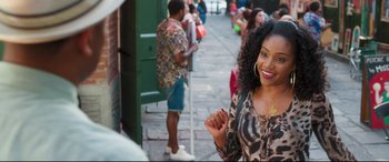 Movie still from “Girls Trip” (2017), directed by Malcolm D. Lee – A woman standing on a sidewalk near a building; Close Up shot, Over the shoulder angle
