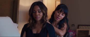 Movie still from “Girls Trip” (2017), directed by Malcolm D. Lee – A woman is helping another woman put on a dress; Close Up shot, Over the shoulder angle