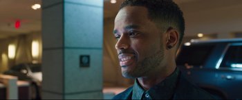 Movie still from “Girls Trip” (2017), directed by Malcolm D. Lee – A person wearing a black shirt; Close Up shot, Over the shoulder angle