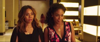 Movie still from “Girls Trip” (2017), directed by Malcolm D. Lee – Two beautiful young women standing next to each other; Close Up shot, Over the shoulder angle