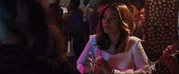 Movie still from “Girls Trip” (2017), directed by Malcolm D. Lee – A woman sitting at a table with a glass of wine; Close Up shot, Over the shoulder angle