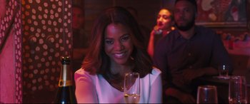Movie still from “Girls Trip” (2017), directed by Malcolm D. Lee – A beautiful woman holding a glass of wine; Close Up shot, Over the shoulder angle