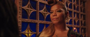 Movie still from “Girls Trip” (2017), directed by Malcolm D. Lee – A person wearing a necklace; Close Up shot, Over the shoulder angle