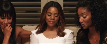 Movie still from “Girls Trip” (2017), directed by Malcolm D. Lee – A woman sitting on a couch with her eyes closed; Close Up shot, Over the shoulder angle