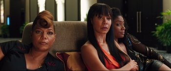 Movie still from “Girls Trip” (2017), directed by Malcolm D. Lee – A group of women sitting next to each other on a couch; Medium shot, Over the shoulder angle