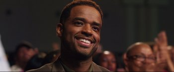 Movie still from “Girls Trip” (2017), directed by Malcolm D. Lee – A person with a smile on their face; Close Up shot, Over the shoulder angle