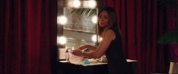 Movie still from “Girls Trip” (2017), directed by Malcolm D. Lee – A beautiful young lady sitting in front of a mirror; Medium shot, Over the shoulder angle