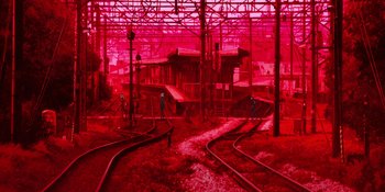 Movie still from “Evangelion: 3.0+1.01 Thrice Upon a Time” (2021), directed by Joe Fria – A train yard with a train on the tracks; Extreme Wide shot, High angle