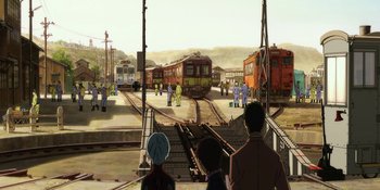 Movie still from “Evangelion: 3.0+1.01 Thrice Upon a Time” (2021), directed by Joe Fria – A group of people standing on a train platform; Extreme Wide shot, High angle