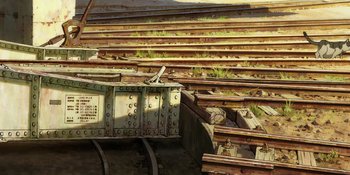 Movie still from “Evangelion: 3.0+1.01 Thrice Upon a Time” (2021), directed by Joe Fria – An old train track with a train on it's side; Extreme Wide shot, Overhead angle