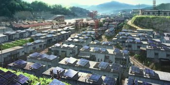 Movie still from “Evangelion: 3.0+1.01 Thrice Upon a Time” (2021), directed by Joe Fria – An aerial view of a city with many solar panels on rooftops; Extreme Wide shot, High angle