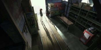 Movie still from “Evangelion: 3.0+1.01 Thrice Upon a Time” (2021), directed by Joe Fria – A woman standing in a room next to boxes; Extreme Wide shot, High angle